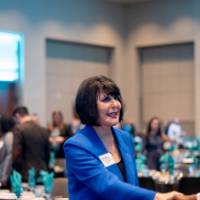 President Mantella shaking hands with Graduate Assistant Albert Okweial